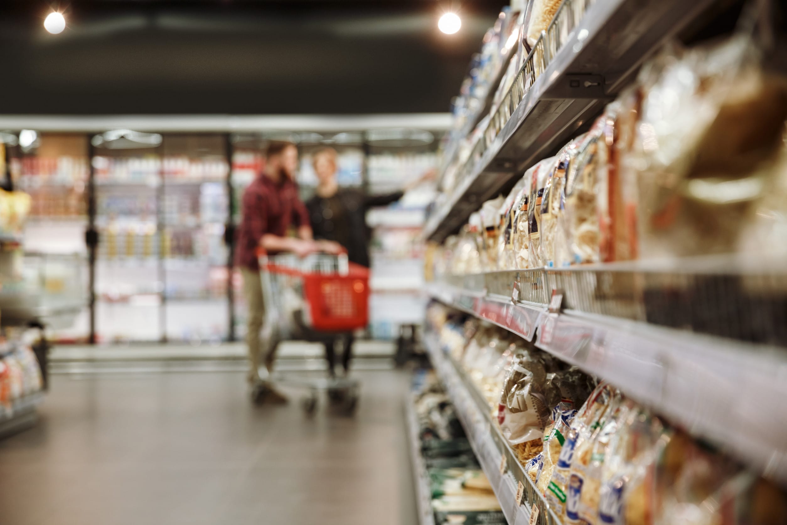 Concentrated young loving couple in supermarket