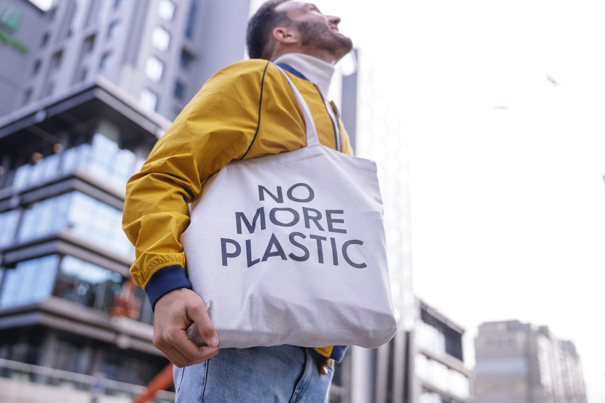 Positive delighted bearded male person looking upwards eco-friendly products
